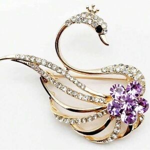 Intricate Gold and Purple Brooch in Swan Design